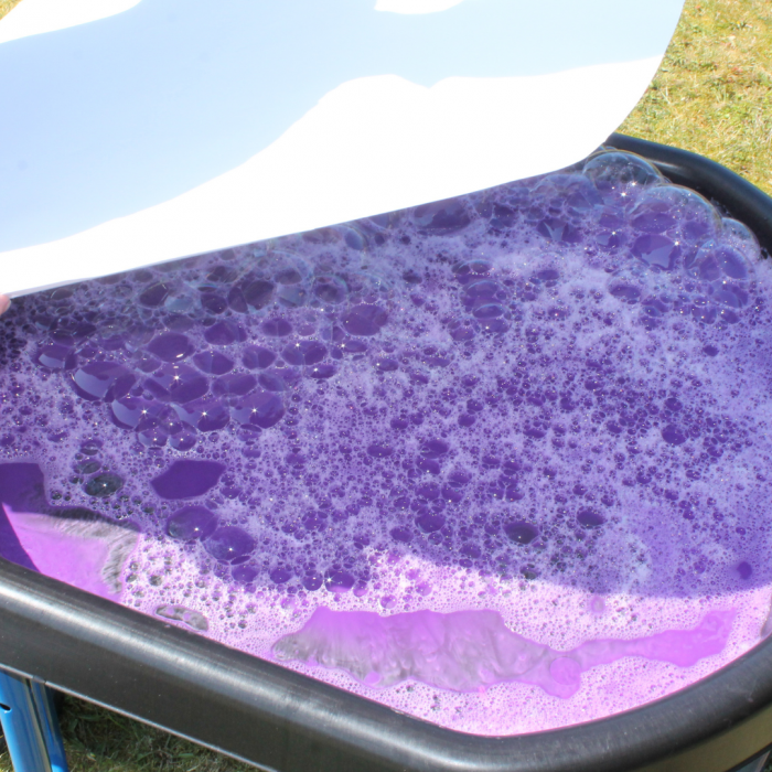 purple soapy water in tuff tray